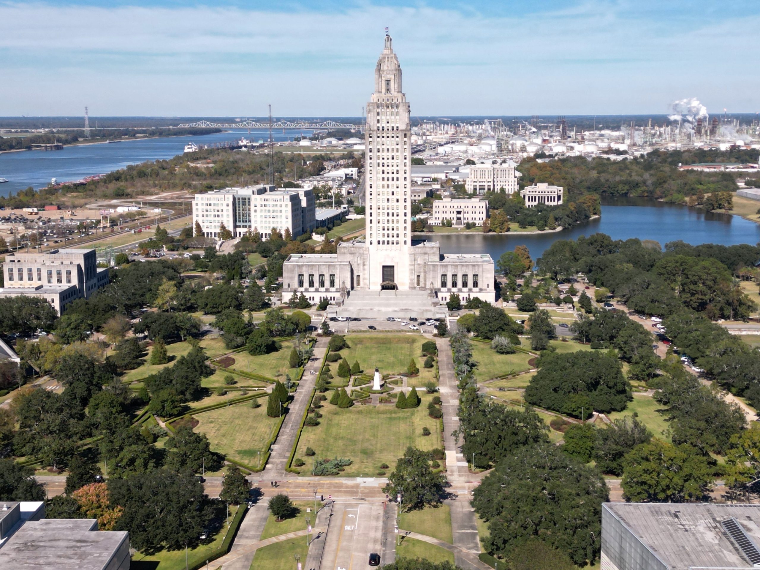 A drone view of the Louisiana State Capitol in Baton Rouge, Louisiana over green parks